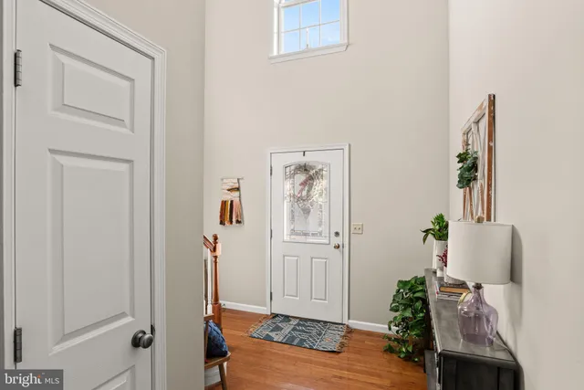 wooden floor with white walls and stairs
