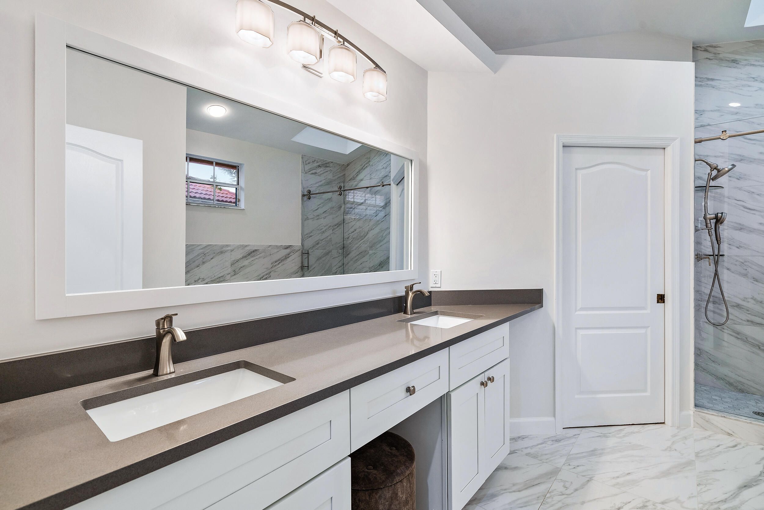 207 Eagleton Estates Boulevard Palm Beach Gardens, FL 33418 - Photo 9 of 34 a bathroom with a sink and a mirror