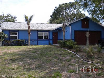8044 Anhinga Road Fort Myers, FL 33967 - Photo 1 of 5 a front view of a house with garden