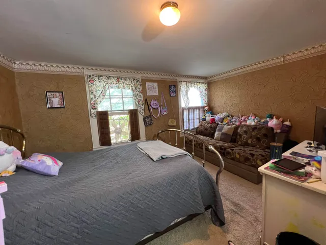 a bedroom with a bed and window