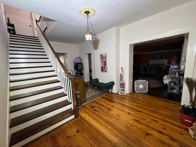a view of a livingroom with furniture and staircase