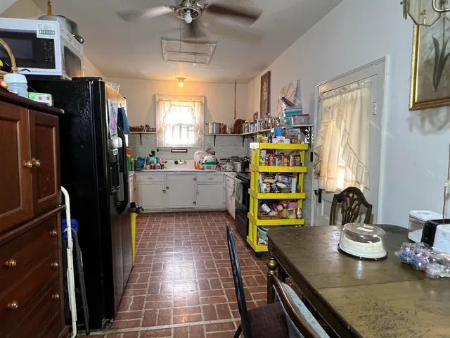 a kitchen with stainless steel appliances granite countertop a sink and a refrigerator