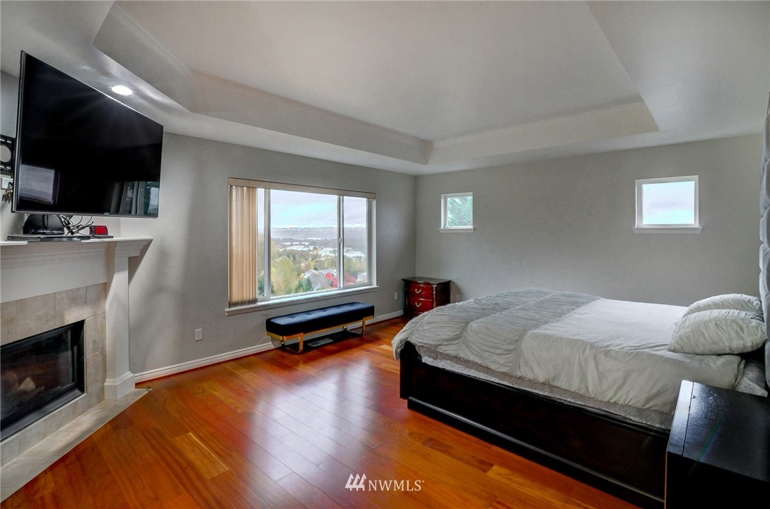 1217 South 36th Place Renton, WA 98055 - Photo 18 of 30 a bed room with a bed and a television