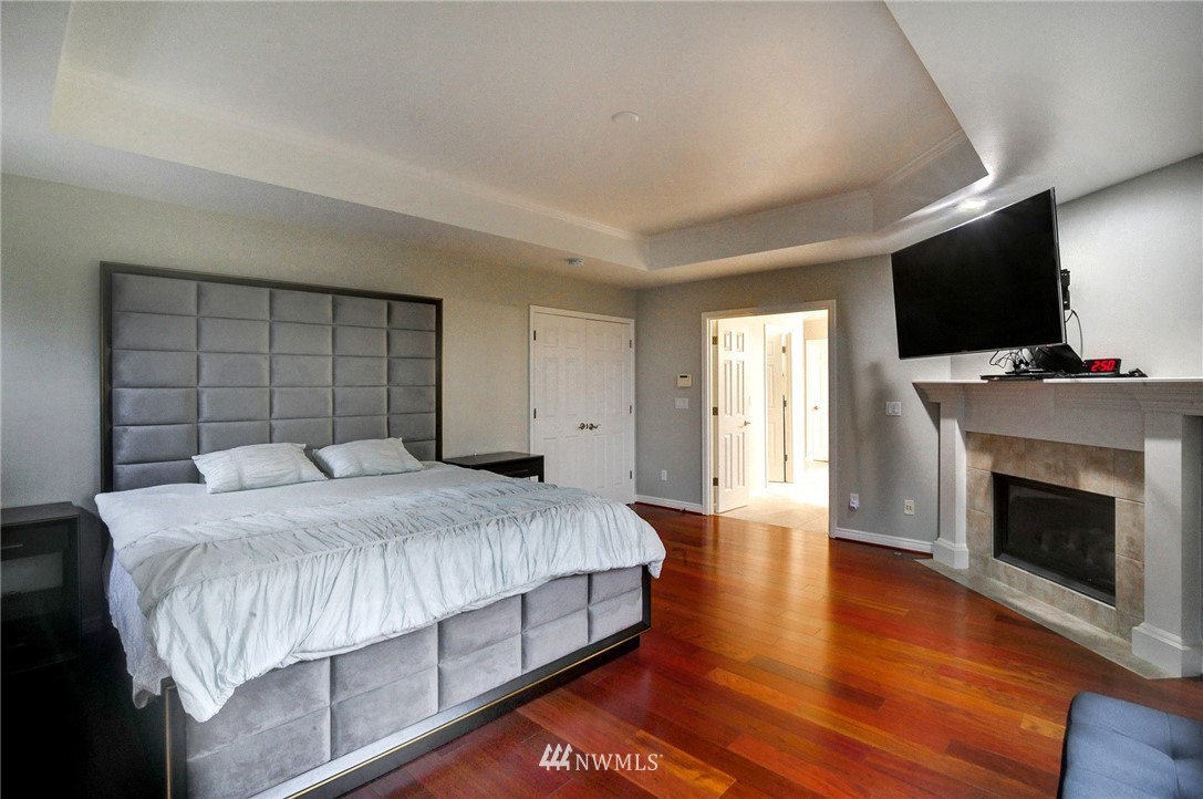 1217 South 36th Place Renton, WA 98055 - Photo 19 of 30 a bedroom with a bed and a flat screen tv