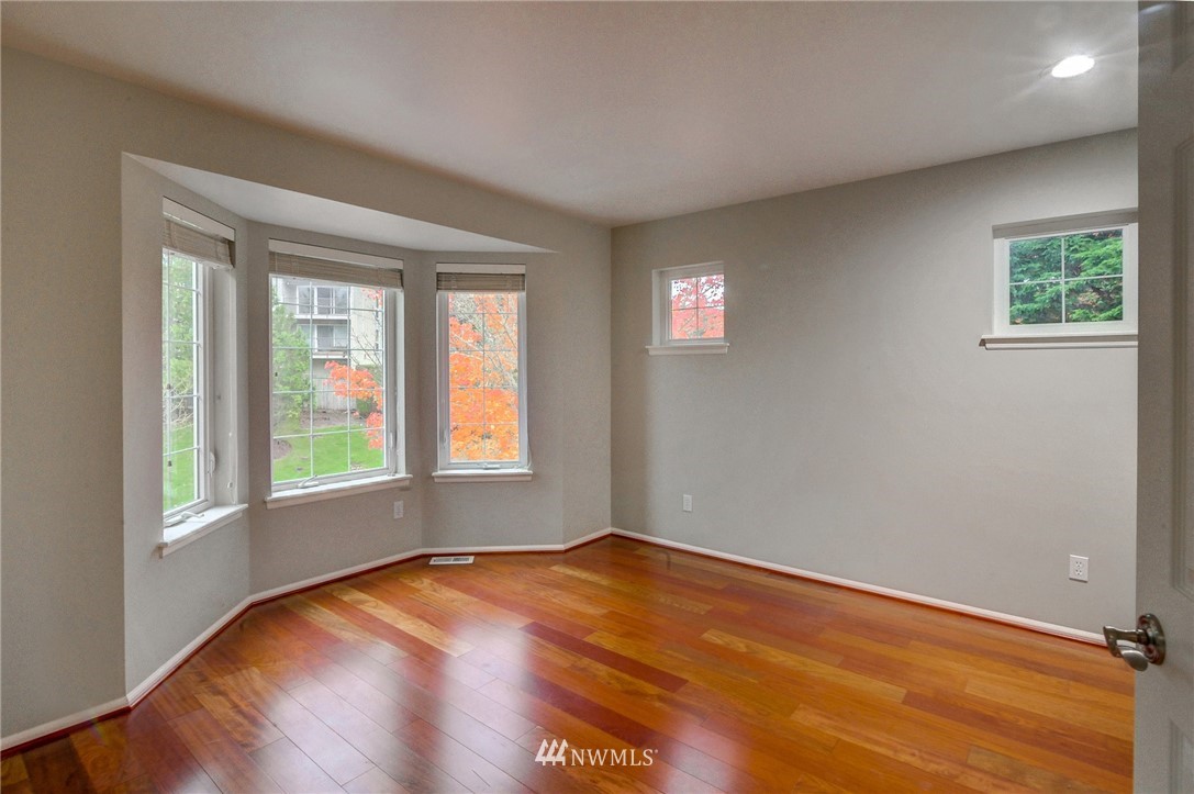 1217 South 36th Place Renton, WA 98055 - Photo 25 of 30 an empty room with wooden floor and windows