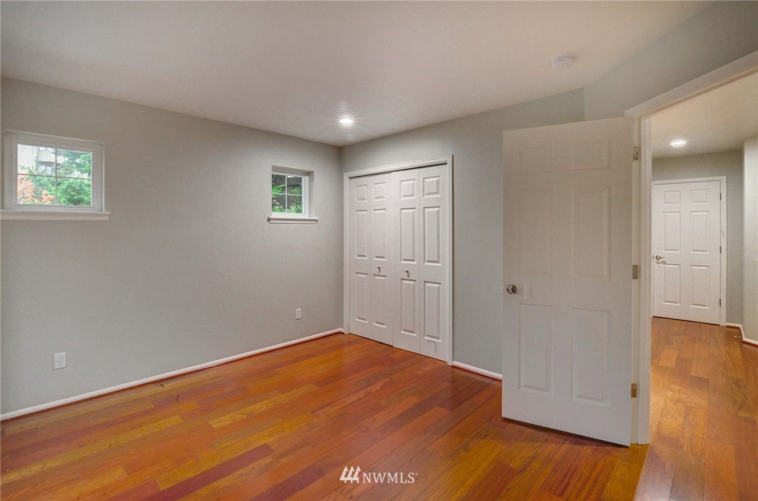 1217 South 36th Place Renton, WA 98055 - Photo 26 of 30 an empty room with wooden floor and windows