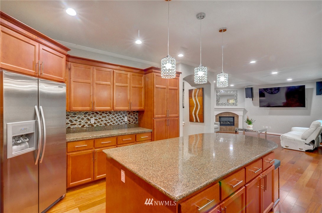 1217 South 36th Place Renton, WA 98055 - Photo 9 of 30 a kitchen with stainless steel appliances granite countertop a sink a stove and a refrigerator