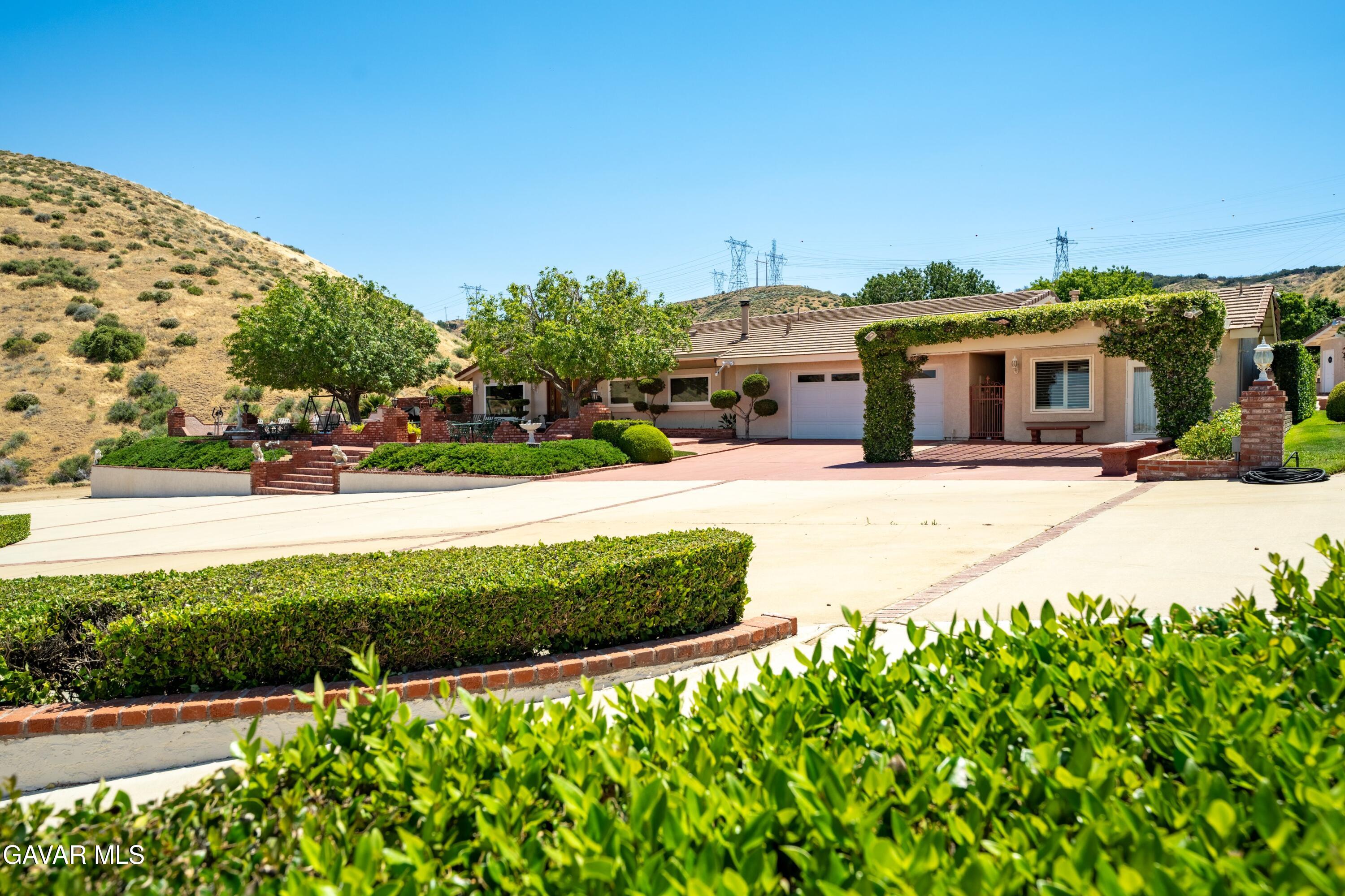 5801 Hacienda Ranch Road Palmdale, CA 93551 - Photo 46 of 69 a front view of a house with a yard