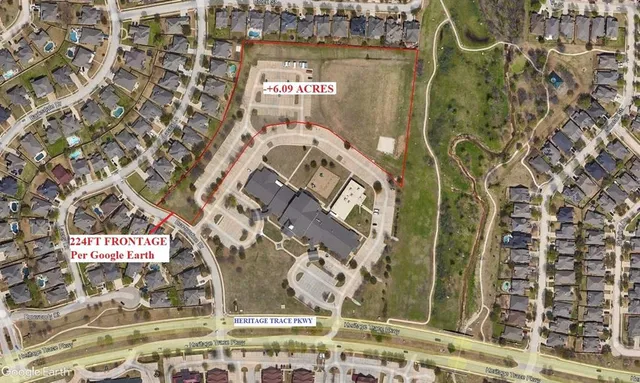 a view of a brick wall with a building in the background