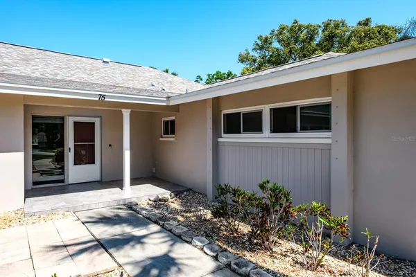 a kitchen with granite countertop a stove sink and cabinets