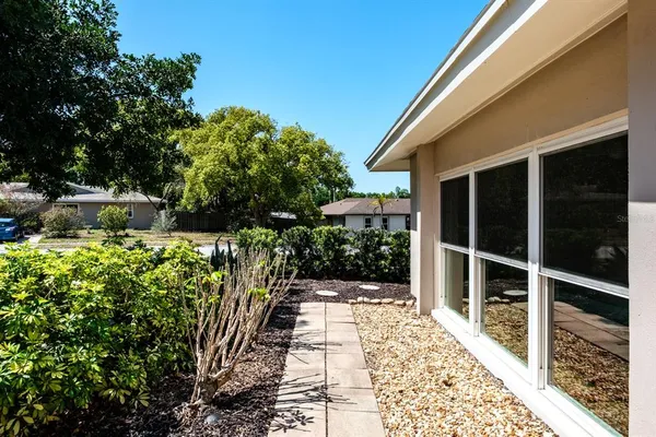 a kitchen with granite countertop a sink stainless steel appliances and white cabinets