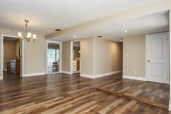 a living room with furniture a ceiling fan and a floor to ceiling window