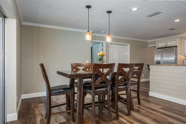a bedroom with a bed and a flat tv screen on dresser