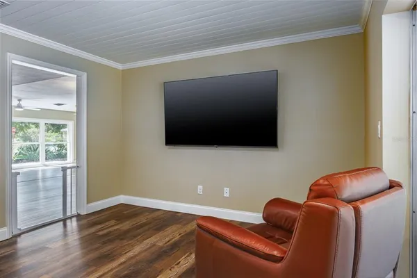 a view of a hallway with wooden floor and closet