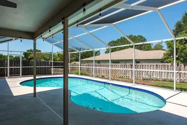 a view of a house with backyard porch and sitting area