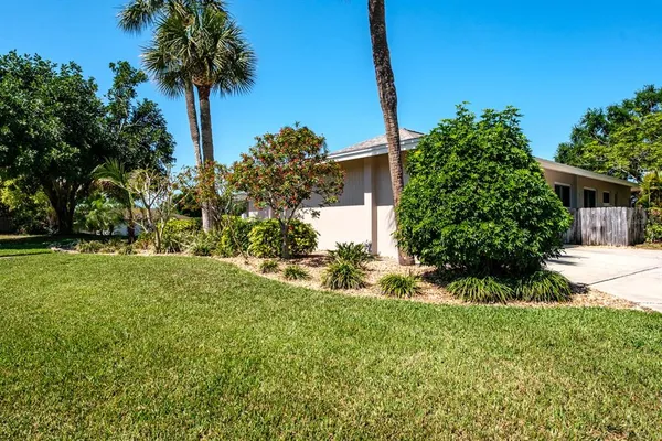 a view of a house with a yard and tree s