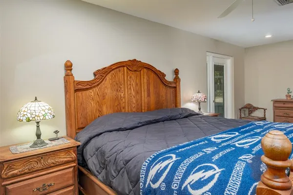 a view of a patio with table and chairs with wooden floor and fence
