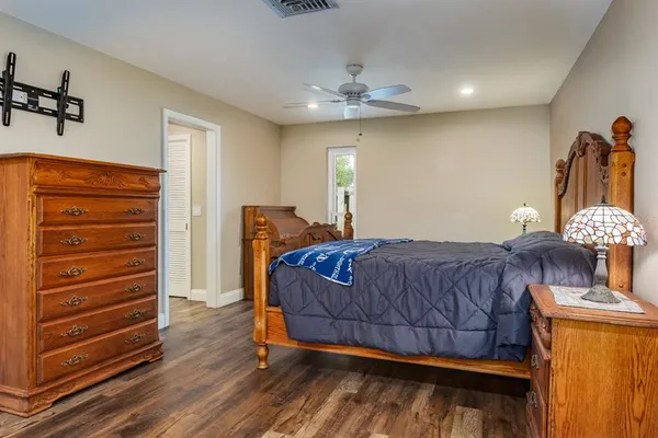 a view of a backyard with wooden fence and a bench