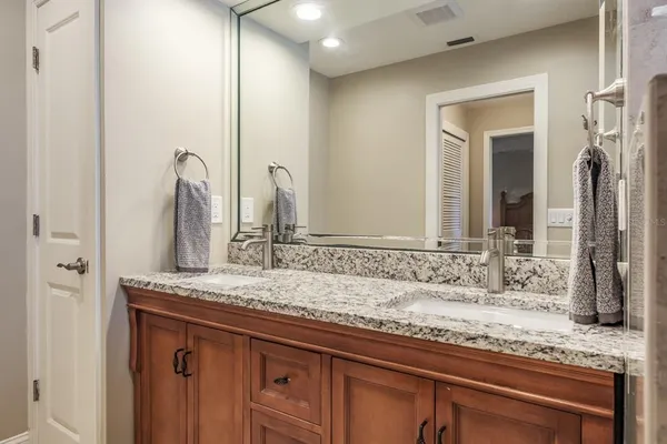 an aerial view of a house with a yard and large trees