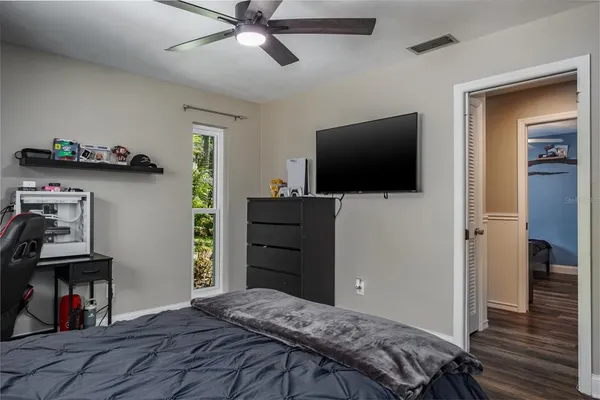 an aerial view of residential houses with outdoor space and trees
