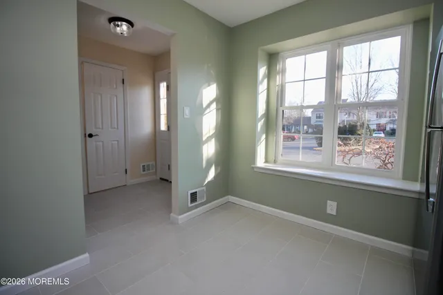 an empty room with windows and closet