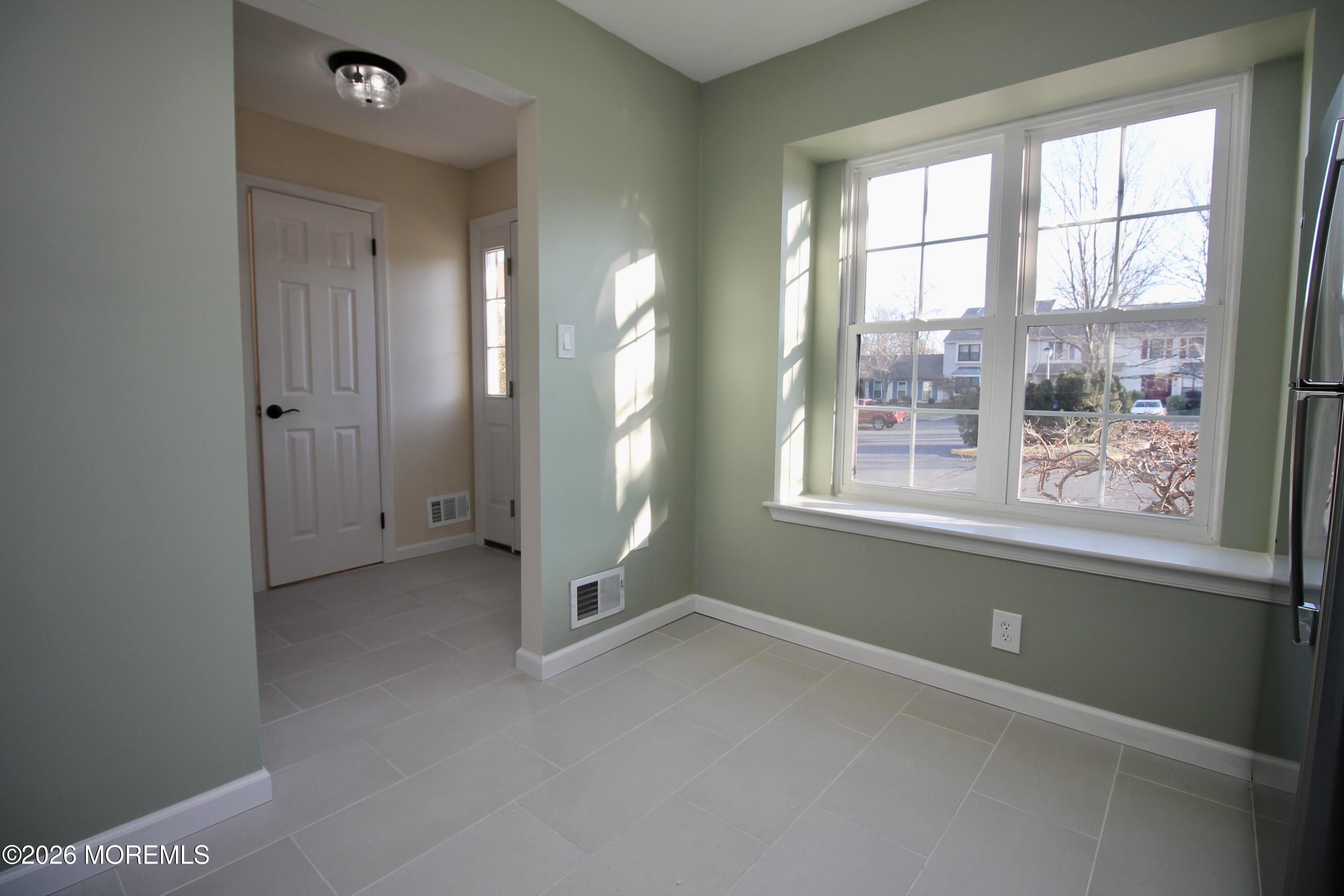 5-2 Claridge Court, Unit 2 Freehold, NJ 07728 - Photo 12 of 35 an empty room with windows and closet