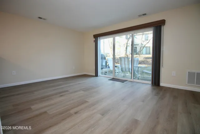 a view of a kitchen with wooden floor and a ceiling fan