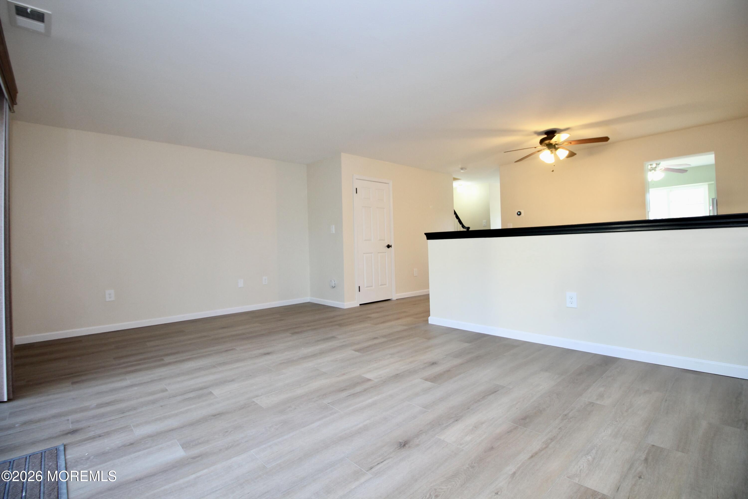 5-2 Claridge Court, Unit 2 Freehold, NJ 07728 - Photo 18 of 35 a view of a kitchen with wooden floor and a ceiling fan