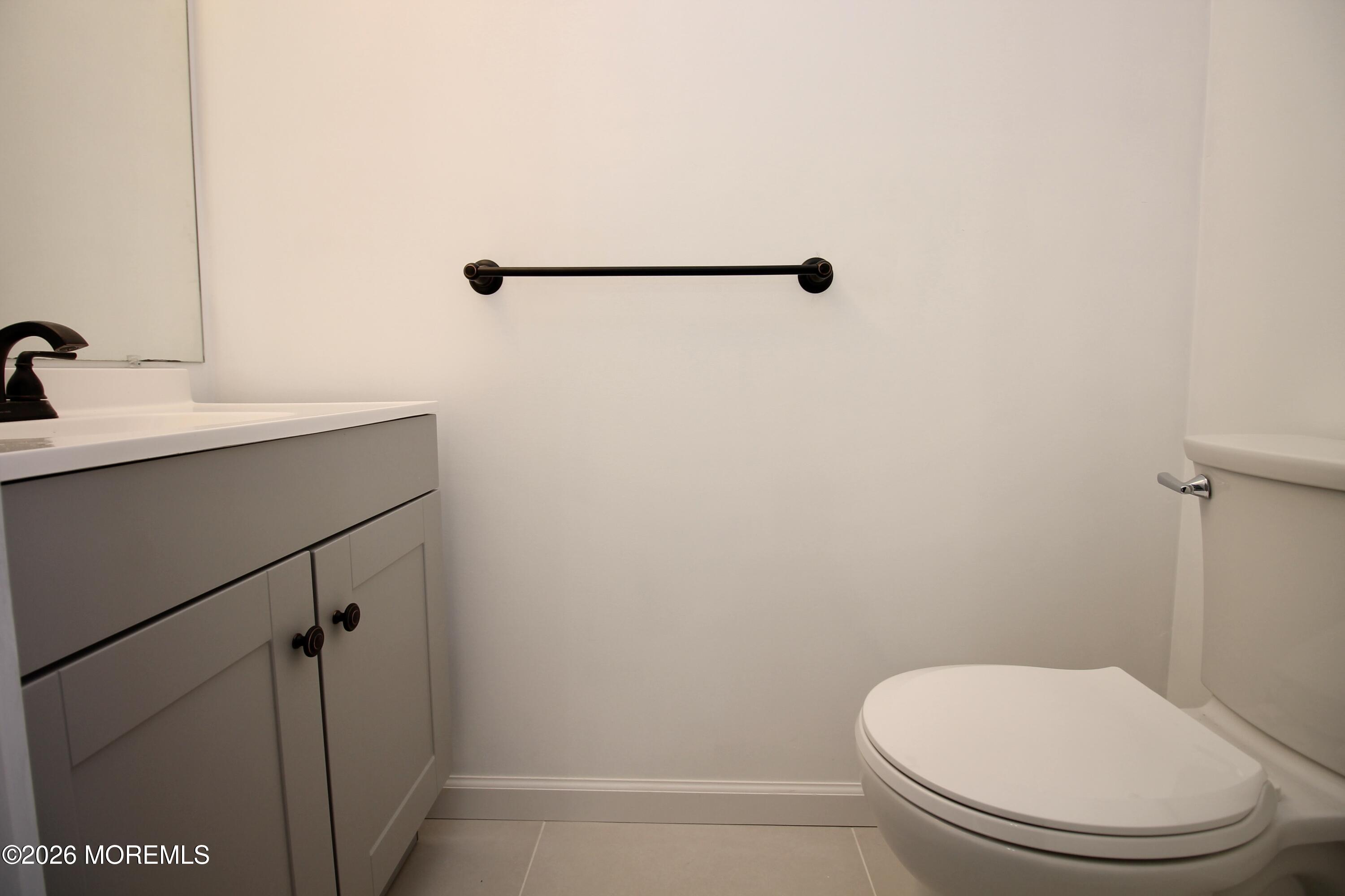 5-2 Claridge Court, Unit 2 Freehold, NJ 07728 - Photo 21 of 35 a bathroom with a toilet and a sink