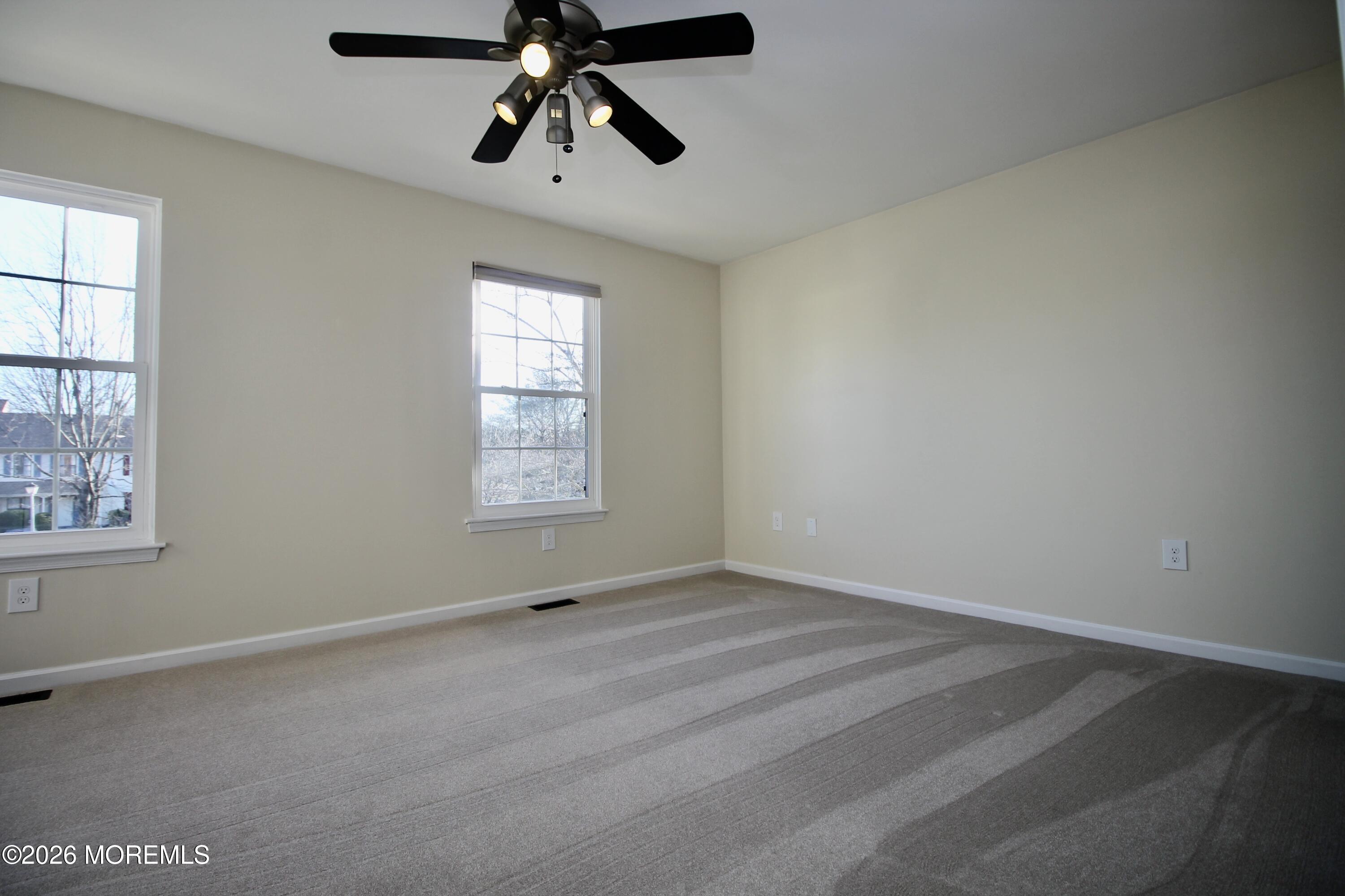 5-2 Claridge Court, Unit 2 Freehold, NJ 07728 - Photo 28 of 35 an empty room with windows