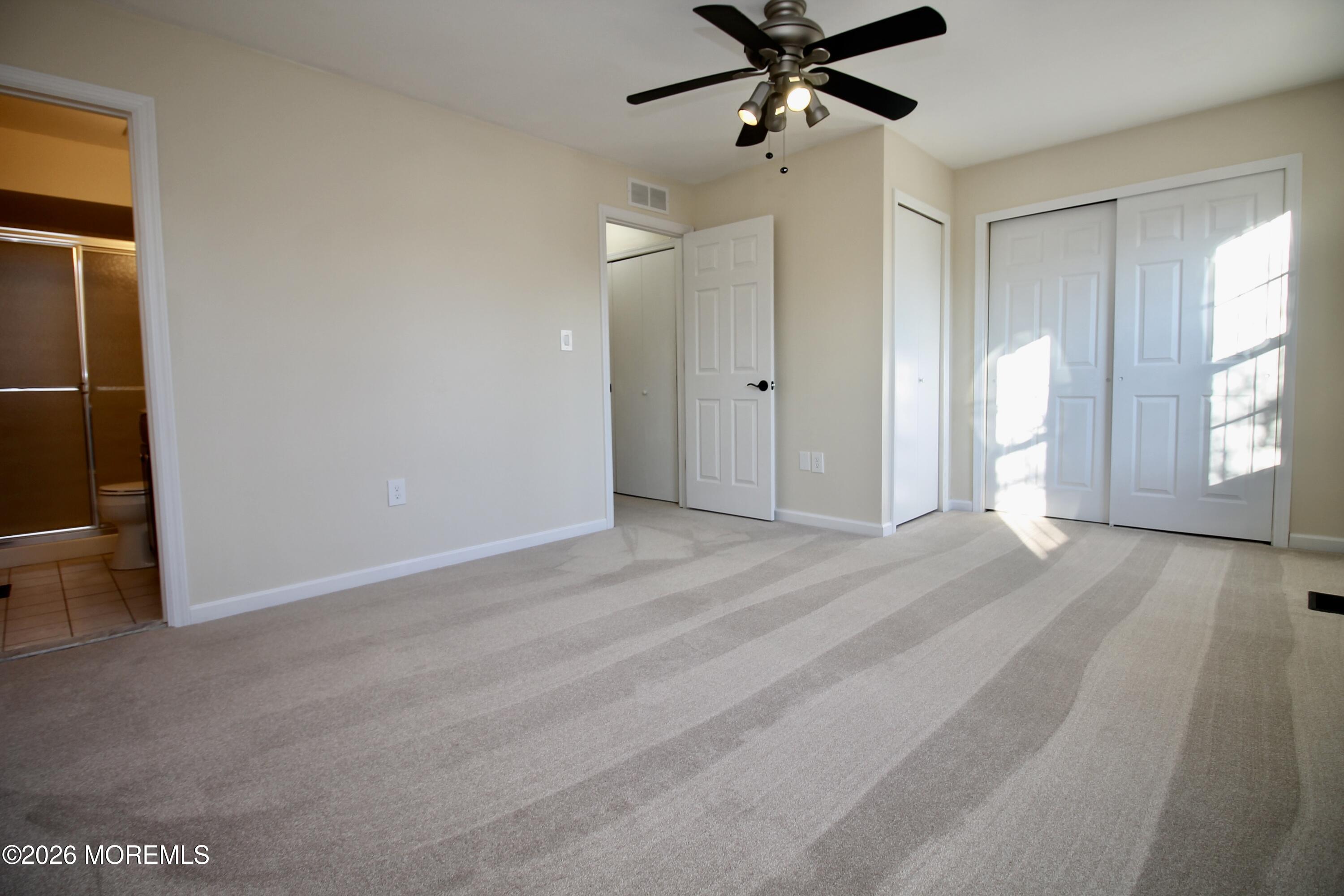 5-2 Claridge Court, Unit 2 Freehold, NJ 07728 - Photo 29 of 35 a view of an empty room with a window