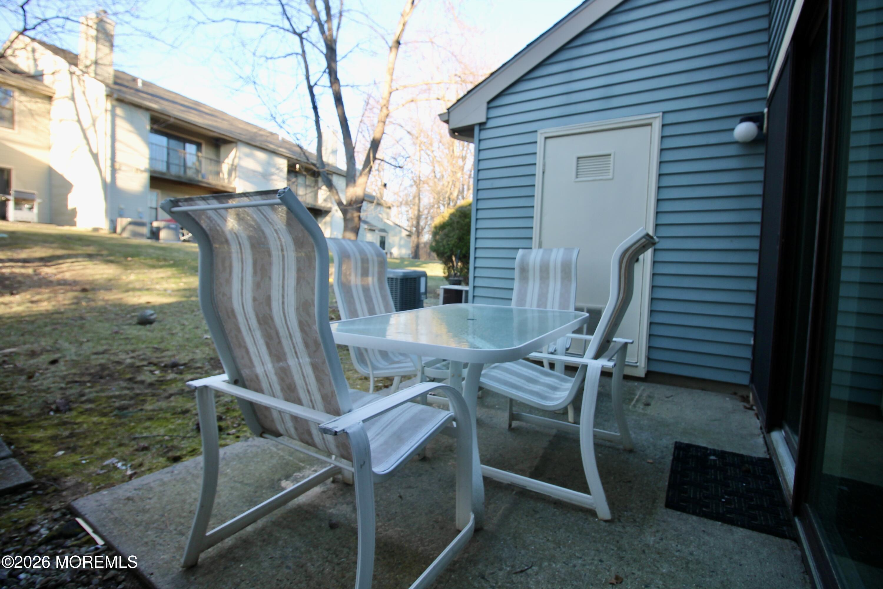 5-2 Claridge Court, Unit 2 Freehold, NJ 07728 - Photo 31 of 35 a view of a patio with table and chairs