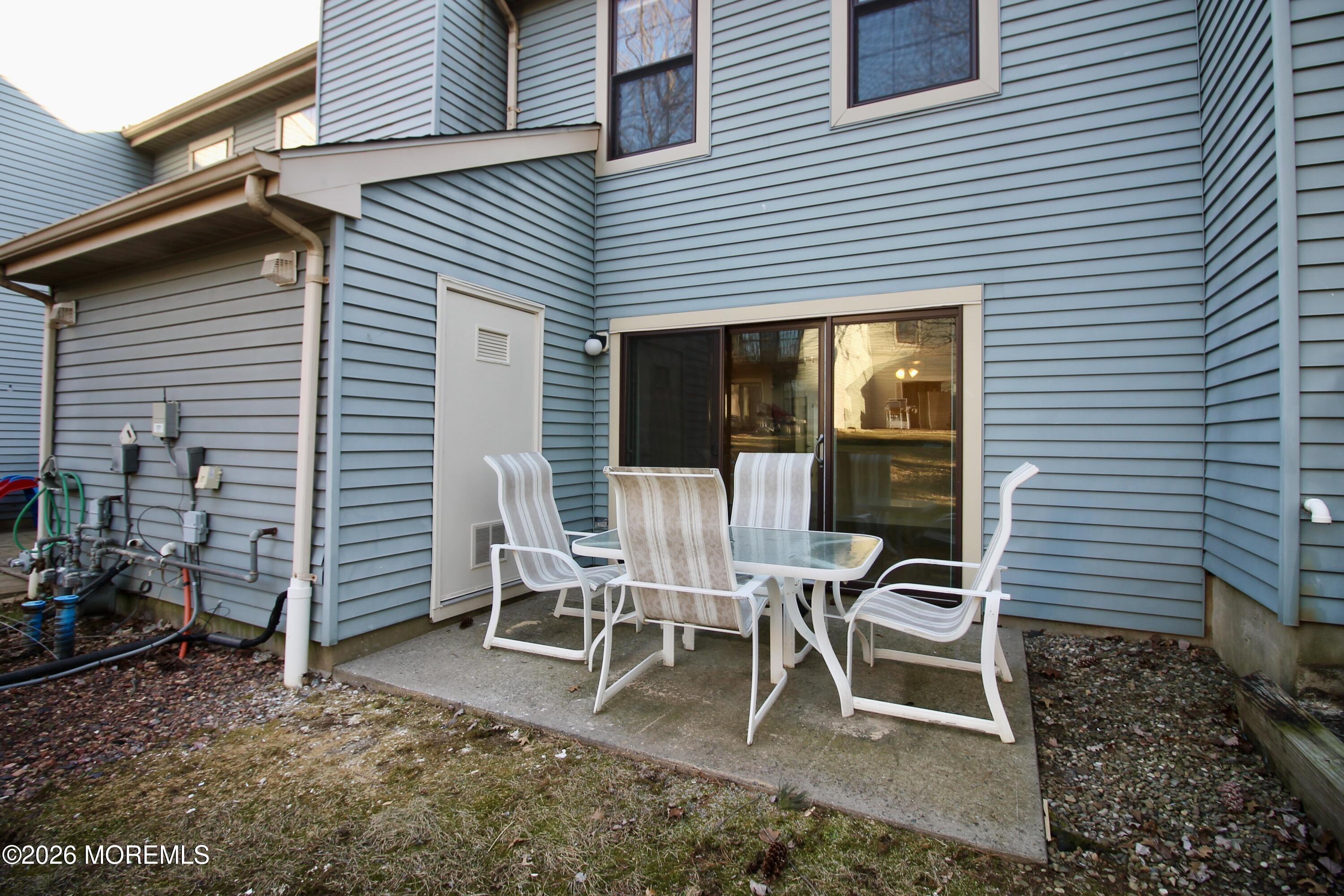 5-2 Claridge Court, Unit 2 Freehold, NJ 07728 - Photo 32 of 35 a wooden bench sitting in front of a house