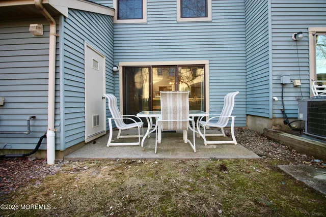 a backyard of a house with table and chairs