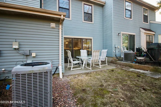 a view of a house with backyard and sitting area