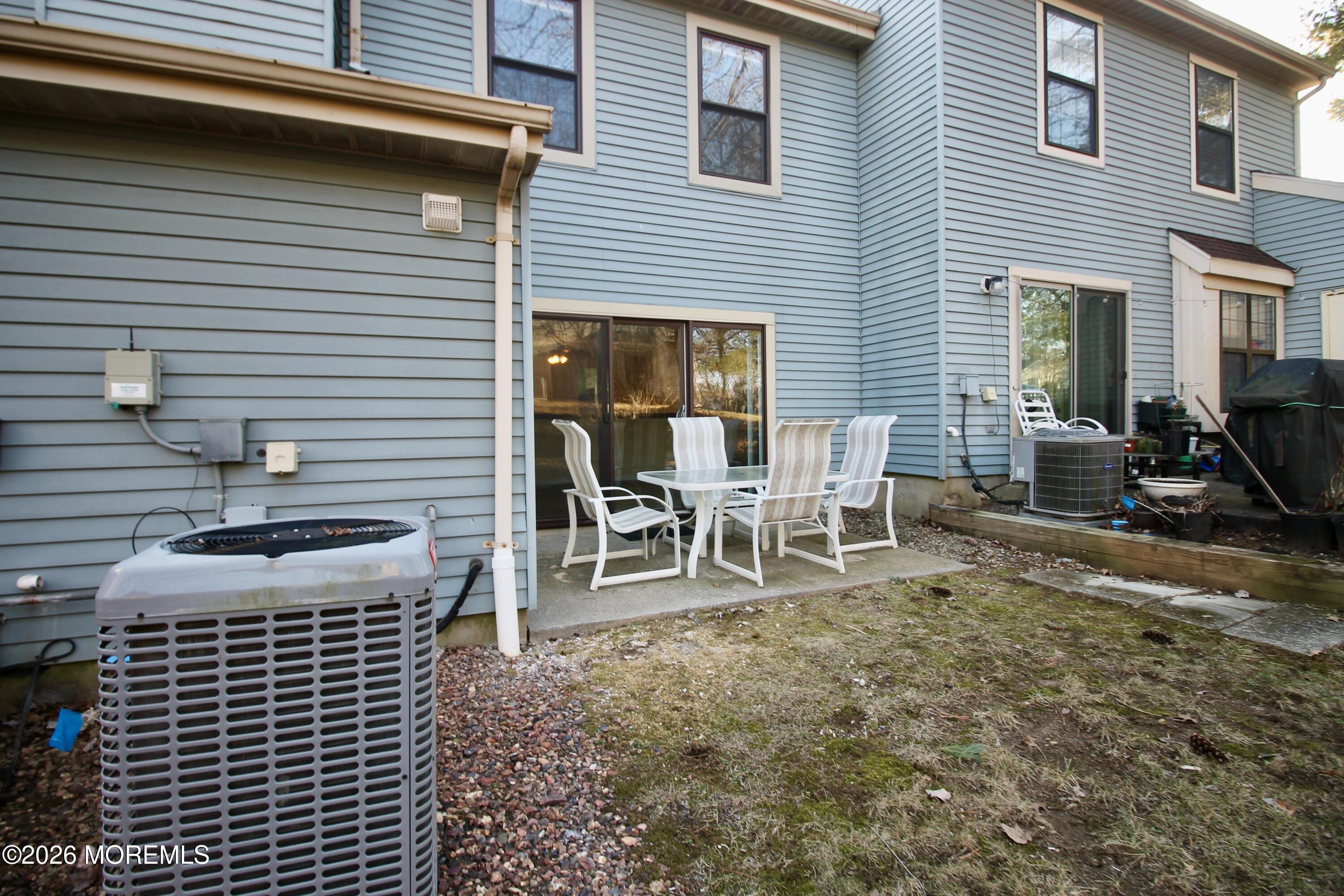 5-2 Claridge Court, Unit 2 Freehold, NJ 07728 - Photo 34 of 35 a backyard of a house with table and chairs