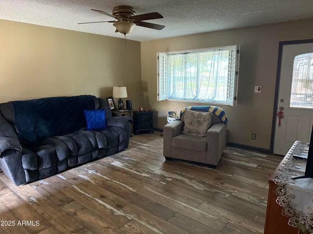 a living room with furniture and a lamp