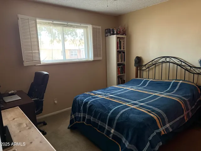 a bedroom with a bed and window