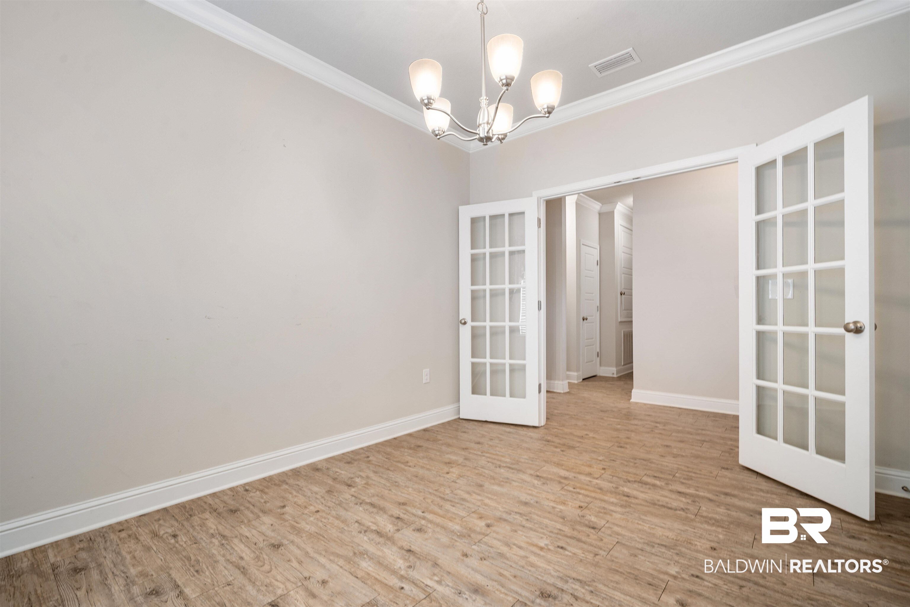 24479 Kipling Court Daphne, AL 36526 - Photo 12 of 41 Unfurnished room featuring crown molding, light wood-style floors, a chandelier, and french doors