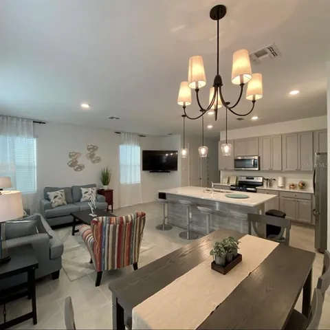 a kitchen with a dining table and chairs