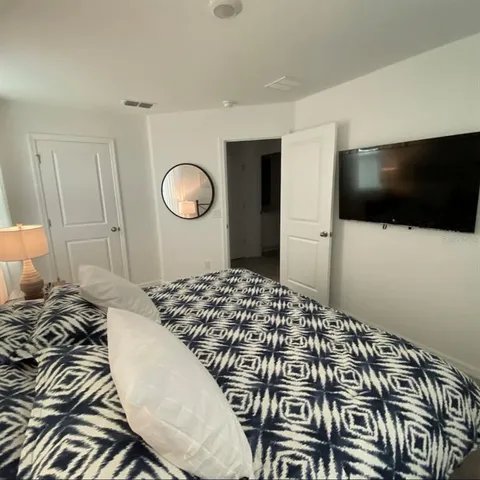 a bedroom with a bed and a window