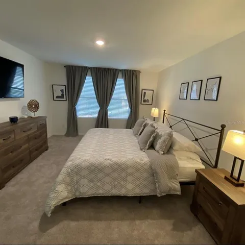 a bedroom with a bed and a night stand