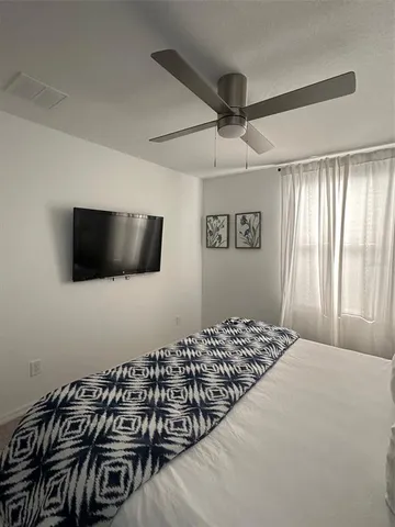 a spacious bedroom with a bed and a couch