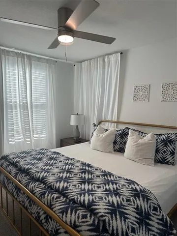 a bedroom with furniture and a gym machine