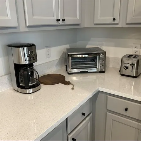 a kitchen with a stove and white cabinets