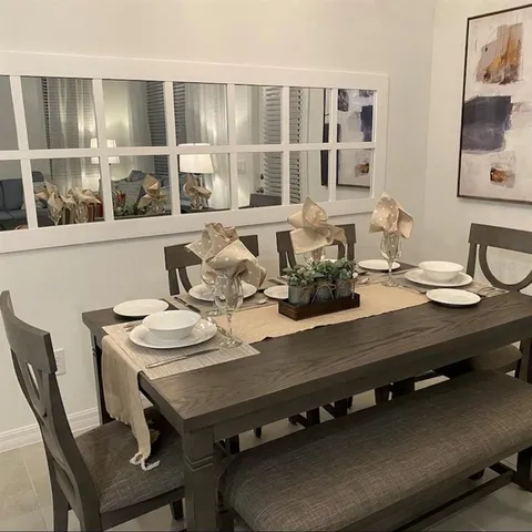 a view of a dining room with furniture window and outside view