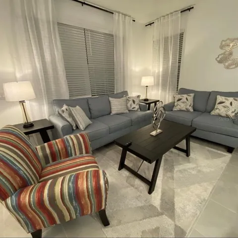 a living room with furniture and a lamp