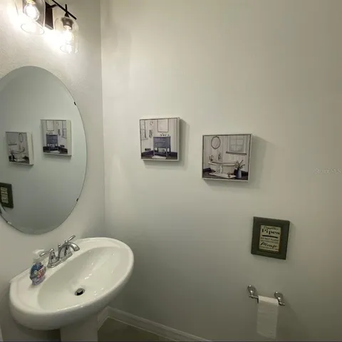a bathroom with a sink and mirror