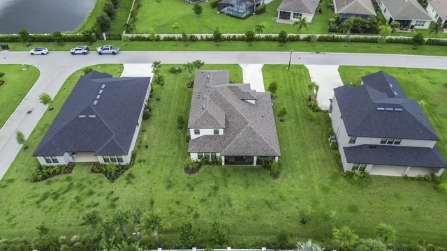 an aerial view of a house with outdoor space and a swimming pool