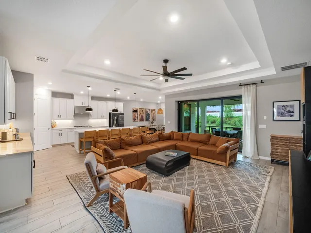 a living room with furniture fireplace and a large window